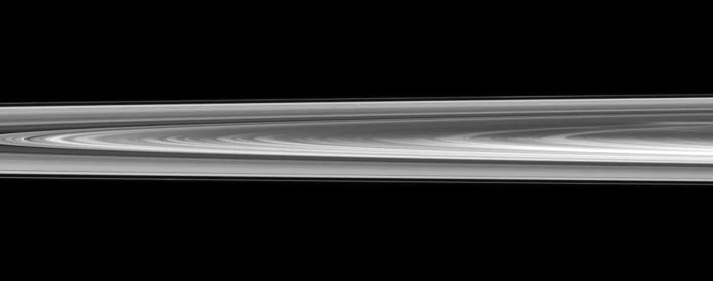 Saturn's rings seen nearly edge-on as a thin bright band.